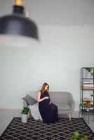 femme enceinte en robe étreint son gros ventre