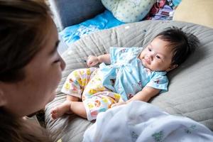 bébé nouveau-né asiatique enfant contact visuel avec maman gentillesse des enfants avec une famille heureuse sur un matelas moelleux métaphore vivre la vie mode de vie sain mignon de produits pour bébé enfant produits de santé pour la mère et le bébé photo