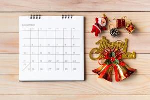 calendrier de décembre et décoration de noël - père noël et cadeau sur table en bois. concept de noël et bonne année photo