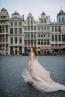 portrait d'une jolie jeune fille vêtue d'une robe luxuriante se promenant dans le parc et le grand palais photo