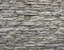 texture d'un mur de pierre. vieux fond de texture de mur de pierre de château. mur de pierre comme arrière-plan ou texture. partie d'un mur de pierre, pour le fond ou la texture