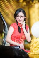 une belle femme asiatique prend une photo dans un costume chinois