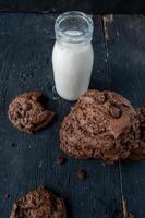 pile de biscuits aux pépites de chocolat avec du lait sur une table en bois rustique