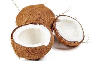 moitiés de noix de coco fraîches cassées et noix de coco entière sur fond blanc photo