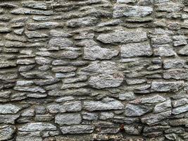 vieux fond de mur de pierre. toile de fond en pierre photo