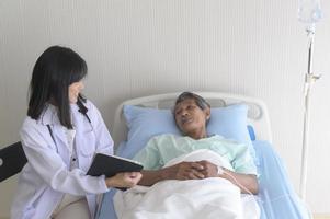 un patient masculin senior asiatique consulte et visite un médecin à l'hôpital. photo