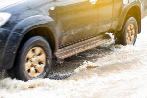 les roues de la voiture ont traversé à toute vitesse inondées. photo