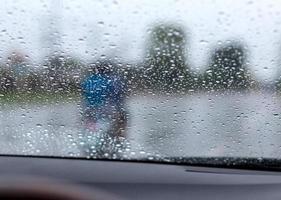 gouttes de pluie sur le pare-brise avec la route. photo