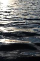 les vagues d'eau de surface brillent en arrière-plan. photo