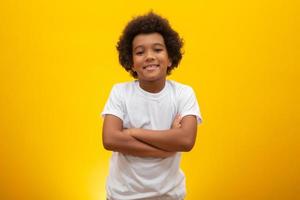 garçon afro-américain aux cheveux noirs sur fond jaune. enfant noir souriant avec des cheveux noirs. garçon noir avec des cheveux noirs. descendance africaine. photo