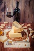 Assiette de fromages assortis avec vin rouge, noix et miel photo