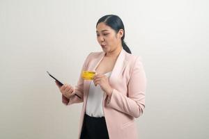 femme asiatique utilisant un smartphone avec une main tenant une carte de crédit photo