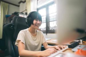 jeune femme asiatique adulte reste à la maison en utilisant un ordinateur pour internet en ligne. photo