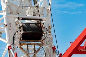 mise au point sélective sur la grue sur chenilles avec élingue de câble métallique sur enrouleur de grue. équipement de levage sur chantier. grue sur chenilles à louer service. grue mobile pour machinerie lourde. rouleau de treuil d'élingue de câble. photo