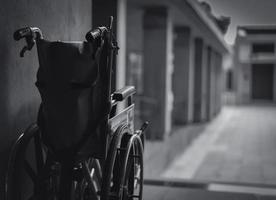 fauteuil roulant plié à côté du mur. triste nouvelle au concept d'hôpital. dépression avec une société vieillissante. fauteuil roulant vide solitaire. équipement médical pour service patient et assistant personnes âgées handicapées photo