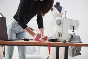 vue particulaire. la créatrice de mode féminine travaille sur les nouveaux vêtements de l'atelier photo