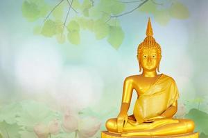 makha bucha day.vesak day.asanha bucha.buddhist lent.buddha statue background blured flowers and sky with the light of the sun. photo