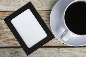 directement au-dessus de la vue du tableau avec une tasse de café sur un bureau en bois. photo