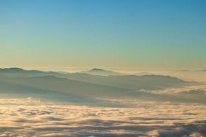 paysage de montagne du lever du soleil coloré dans les montagnes. vue sur le brouillard et les nuages photo