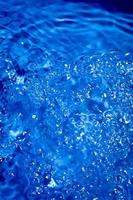 fond d'eau bleu foncé avec des éclaboussures et des bulles. photo