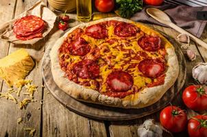 pizza au salami rustique avec du cheddar et du chorizo photo