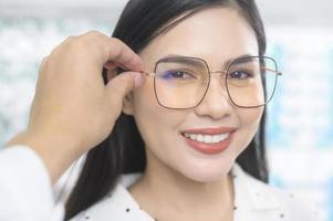 jeune cliente choisissant des lunettes dans un centre optique, concept de soins oculaires. photo