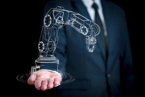 graphiques linéaires représentant le bras d'un robot sur la main d'un homme d'affaires. concept de développement de robots ai pour travailler pour les humains à l'avenir photo