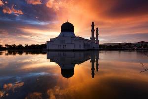reflet de la mosquée de la ville de kota kinabalu au lever du soleil photo