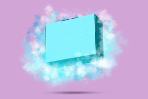 boîte en carton carton bleu volant avec des nuages sur fond rose photo