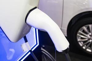 la charge de la batterie de la voiture Nouvelles innovations automobiles l'alimentation électrique branchée sur une voiture électrique en cours de charge, concept d'innovation énergétique. photo