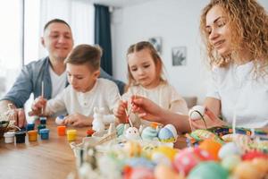 assis près de la table. famille heureuse célébrant les vacances de pâques ensemble photo