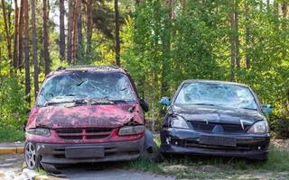 de nombreuses voitures cassées après un accident de la circulation dans le parking d'une station-service de restauration dans la rue. atelier de dommages de carrosserie à l'extérieur. vente aux enchères de véhicules d'urgence d'assurance. photo