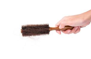 femmes avec problème de cheveux tenant un peigne à cheveux perdu à la main, isolées sur fond blanc photo