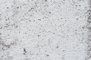 texture d'un mur de béton avec des fissures et des rayures qui peuvent être utilisées comme arrière-plan photo