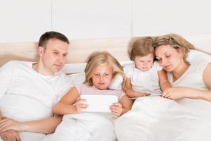 jeune famille, utilisation, ordinateurs portables, lit