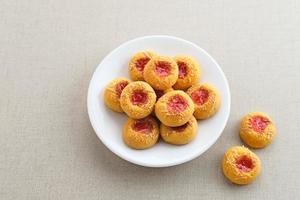 biscuits à empreinte de pouce remplis de confiture de fraises et de fromage râpé. familier pendant le mois de ramadan et eid fitri. photo