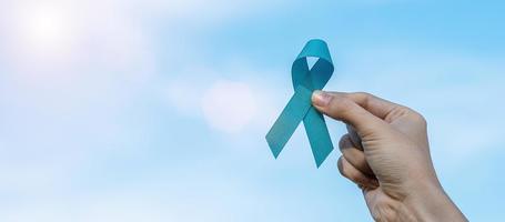 novembre mois de sensibilisation au cancer de la prostate, homme tenant un ruban bleu clair pour soutenir les personnes vivant et malades. soins de santé, hommes internationaux, père, journée mondiale du cancer et concept de journée mondiale du diabète photo