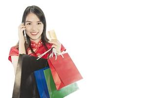 femme asiatique heureuse faisant du shopping dans une suite chinoise isolée sur un espace de copie blanche - concept de journée de la femme photo