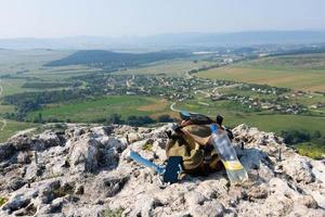 image d'une bouteille en plastique et d'un sac à dos touristique sur une falaise de montagne à l'état sauvage. photo