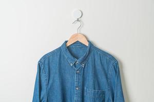 chemise suspendue avec cintre en bois au mur photo