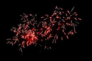 étincelles rouges de feux d'artifice dans le ciel nocturne photo