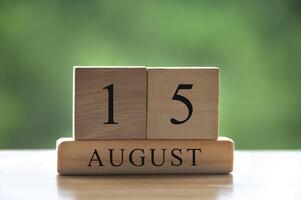 Texte de la date du calendrier du 15 août sur des blocs de bois avec parc d'arrière-plan flou. espace de copie et concept de calendrier photo