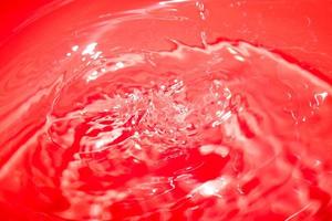 fond chaotique abstrait rouge avec motif sans couture. texture de surface liquide rouge. photo