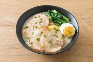 nouilles ramen dans une soupe d'os de porc avec du porc rôti et des œufs photo