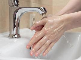 hygiène. nettoyer les mains. se laver les mains à l'eau claire. main de femme. protégez-vous de la pandémie de coronavirus covid-19. gros plan photo