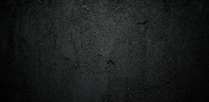 ciment noir gris foncé pour le fond. fond de texture béton pierre noire photo