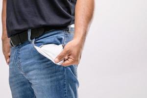 pas d'argent dans la poche du pantalon. homme en gros plan tenant sa poche de pantalon vide pour ne montrer aucun argent à l'intérieur. notion financière photo