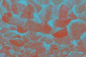 texture de mur de maçonnerie colorée. pierres colorées et rochers de différentes formes sur fond gris. fond de mur de pierre. photo