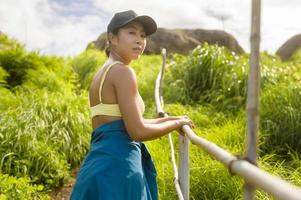 belle femme asiatique en tenue de sport trekking sur sentier de montagne, concept de voyage et d'écotourisme. photo