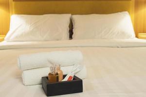 ensemble de serviettes d'hôtel avec brosse à dents et dentifrice sur lit blanc photo